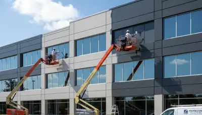Professional commercial painters applying durable coatings in Kissimmee, FL business building exterior