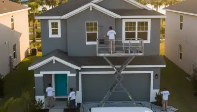 Professional house painters in Kissimmee FL expertly painting a home's exterior for curb appeal